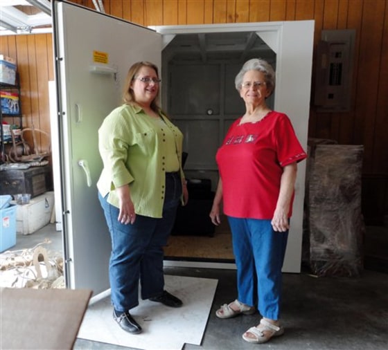Betty and Linda Harryman show off the safe room they installed in the garage of their new home following last year's tornado in Joplin, Mo.